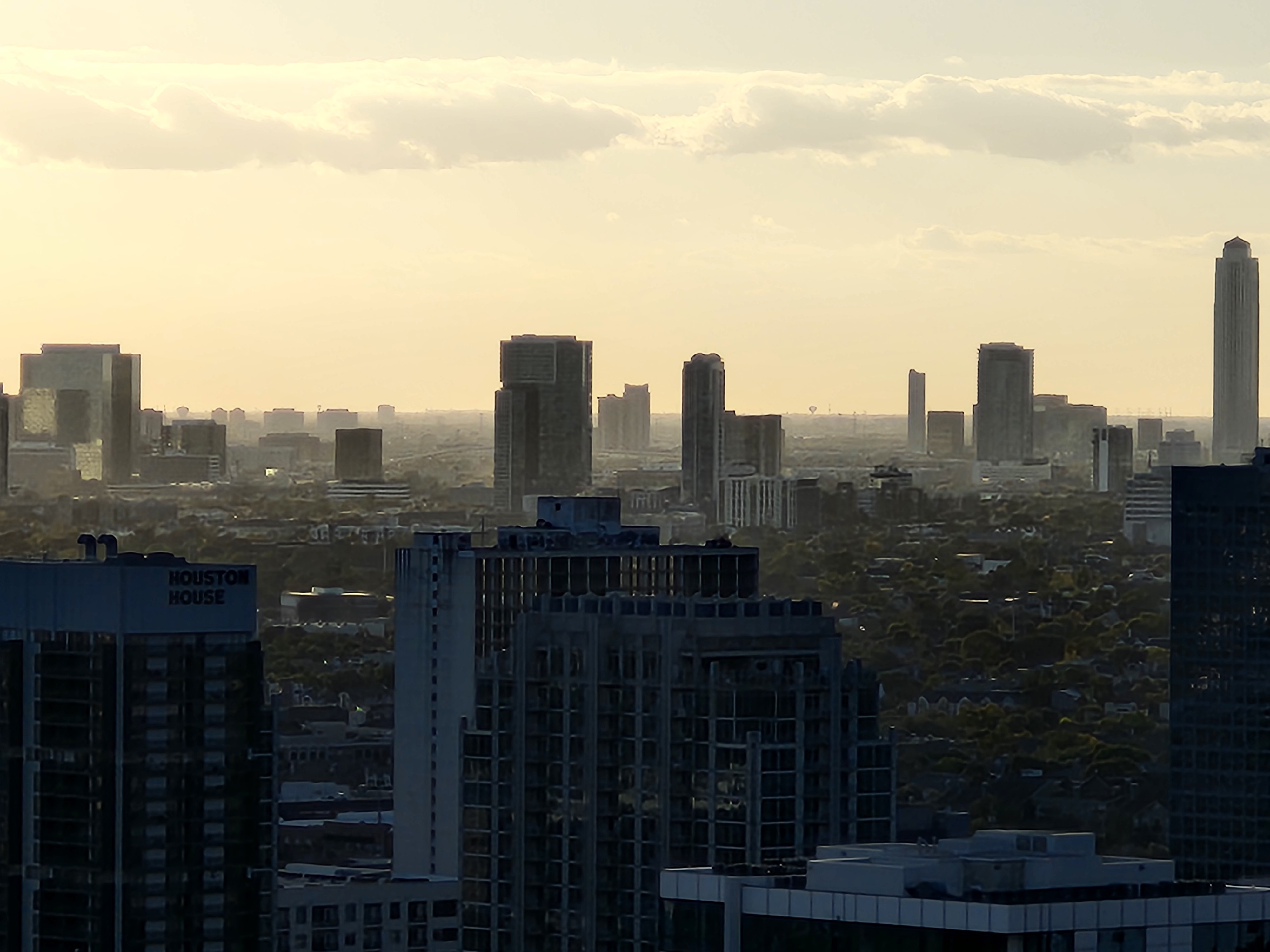image of yellow sky with buildings faded out as they recede into skyline
